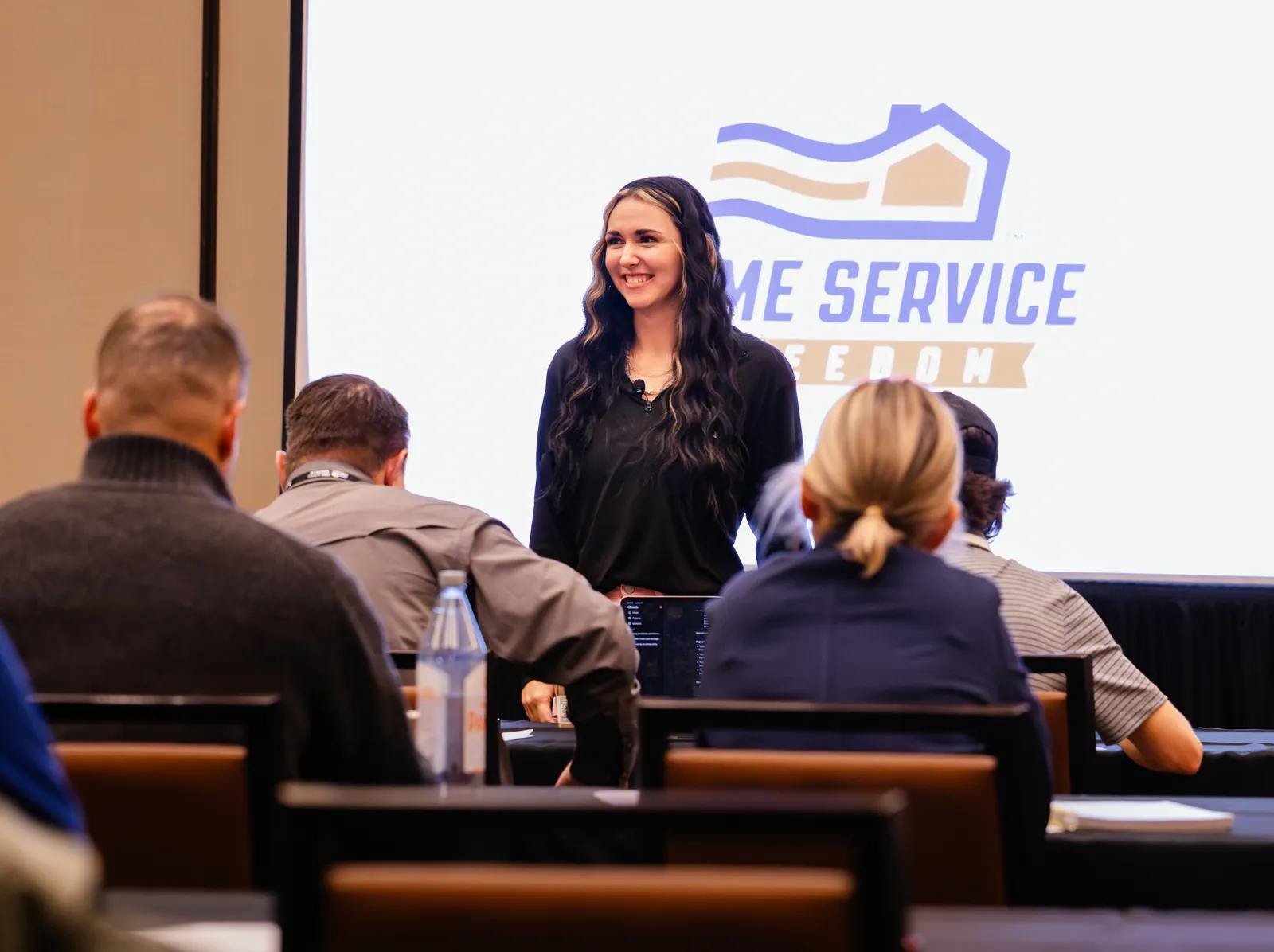 HSF trainer smiling while presenting to members